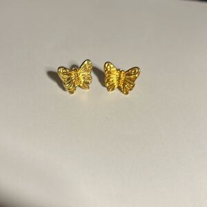 Gold butterfly pierced earrings.